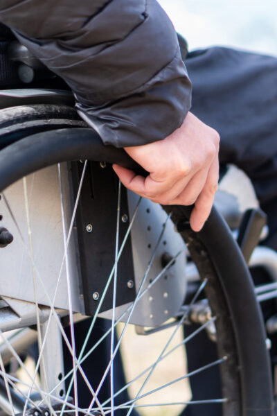 Closeup,Photo,Of,Young,Disabled,Man,Holding,Wheelchair,Outside,In